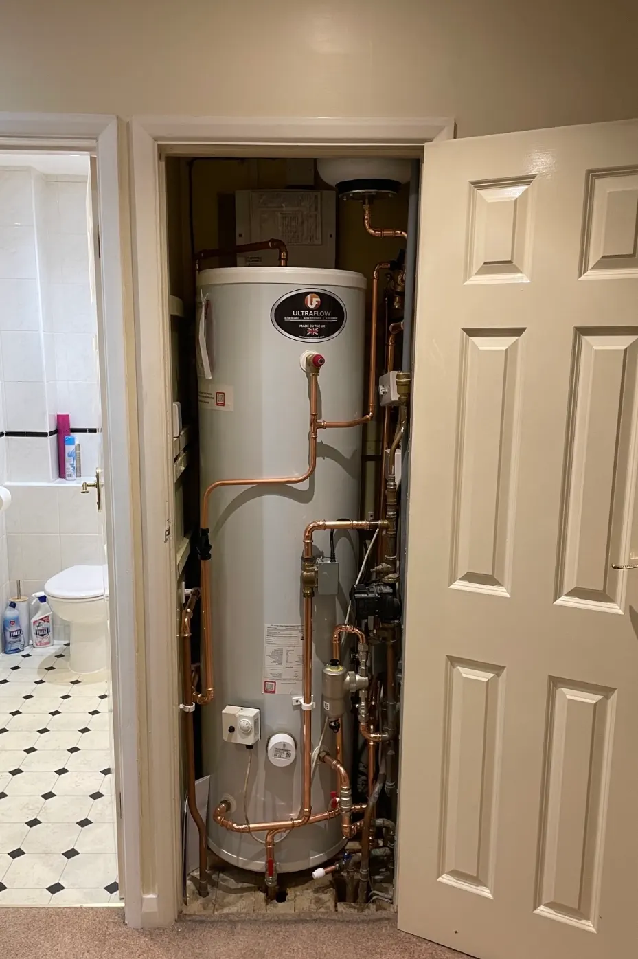 Hot water cylinder in a fitted cupboard from Pureflo's project collection