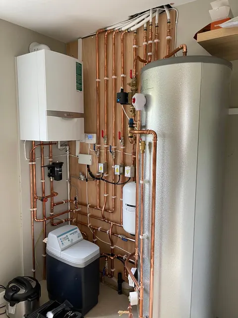 Vaillant boiler, hot water cylinder and neatly arranged copper pipework