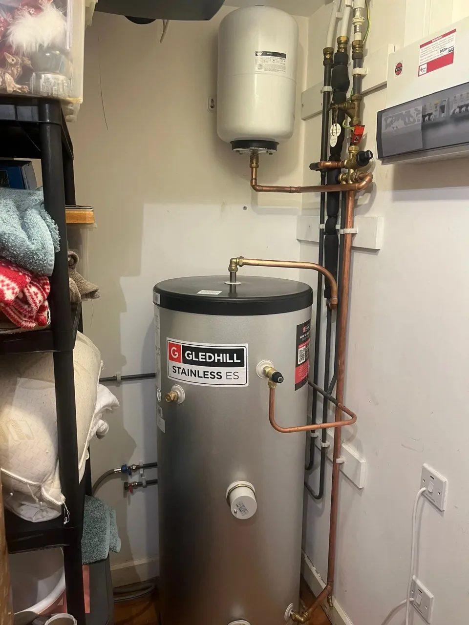 Gledhill stainless hot water cylinder with expansion vessel and connected copper pipes